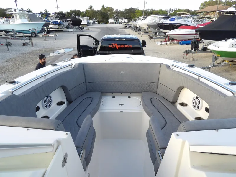 Slide: The Image of 2022 Stingray 269 DC boat with spacious seating, parked in a marina. - 44