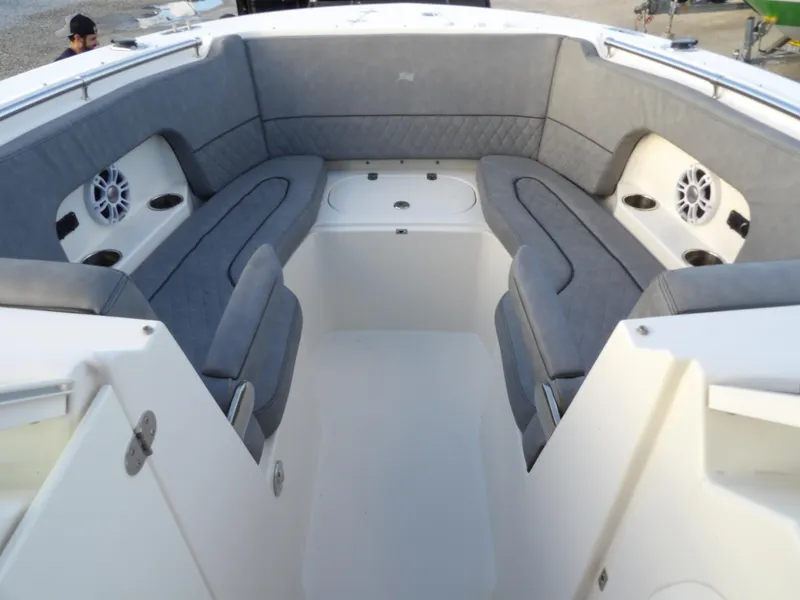 Slide: The Image of 2022 Stingray 269 DC boat interior with gray seating and built-in speakers. - 45
