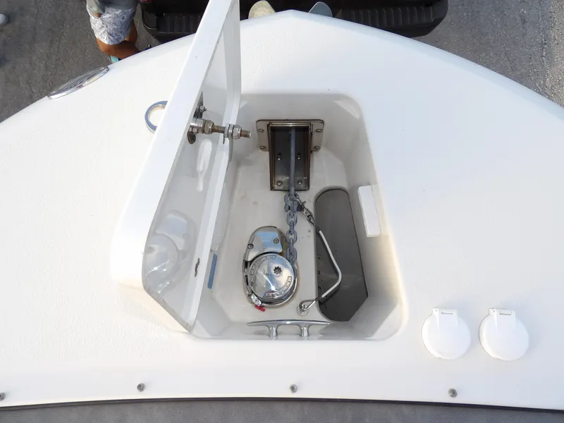 Slide: The Image of Anchor storage compartment on 2022 Stingray 269 DC boat, featuring chain and winch. - 49