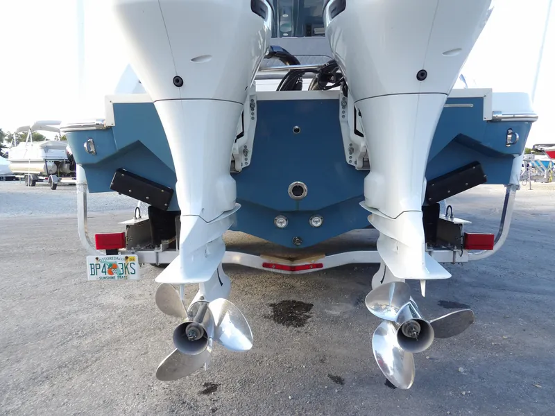 Slide: The Image of 2022 Stingray 269 DC boat with dual outboard motors and propellers, rear view. - 8