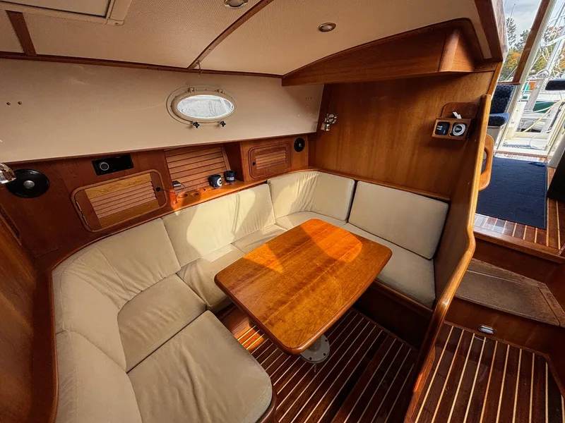Slide: The Image of Interior of 2005 Hinckley Talaria 44 MY yacht with cozy seating and wooden table. - 8