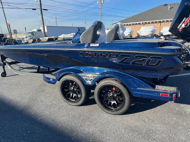 Slide: The Image of 2025 Nitro Z20 XL Pro boat with dual axle trailer in a parking lot. - 1