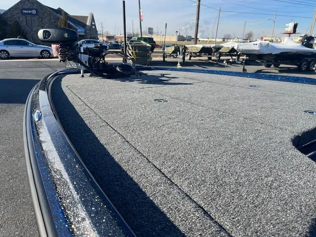 Slide: The Image of 2025 Nitro Z20 XL Pro boat deck with fishing equipment in a marina setting. - 15