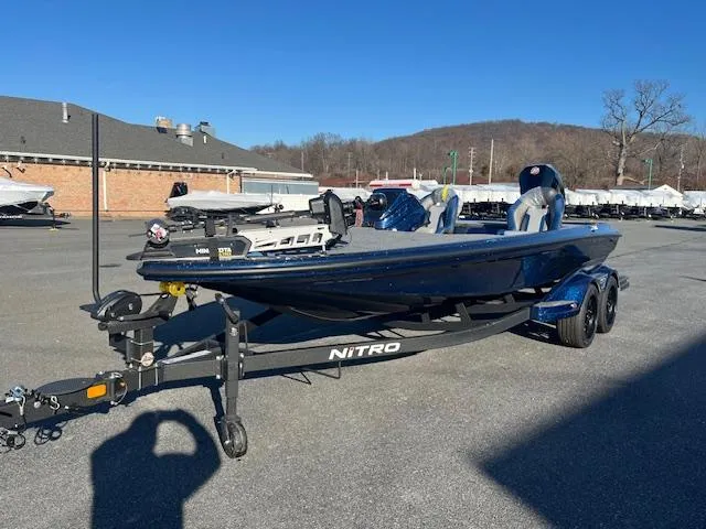 Slide: The Image of 2025 Nitro Z20 XL Pro boat on trailer in parking lot, clear blue sky. - 3