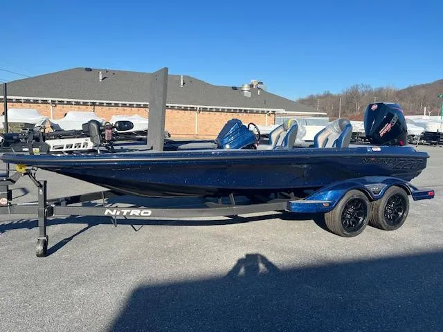 Slide: The Image of 2025 Nitro Z20 XL Pro bass boat on trailer, parked outdoors. - 4