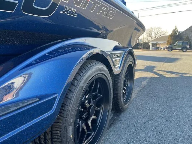 Slide: The Image of 2025 Nitro Z20 XL Pro boat trailer with black wheels on a sunny day. - 6