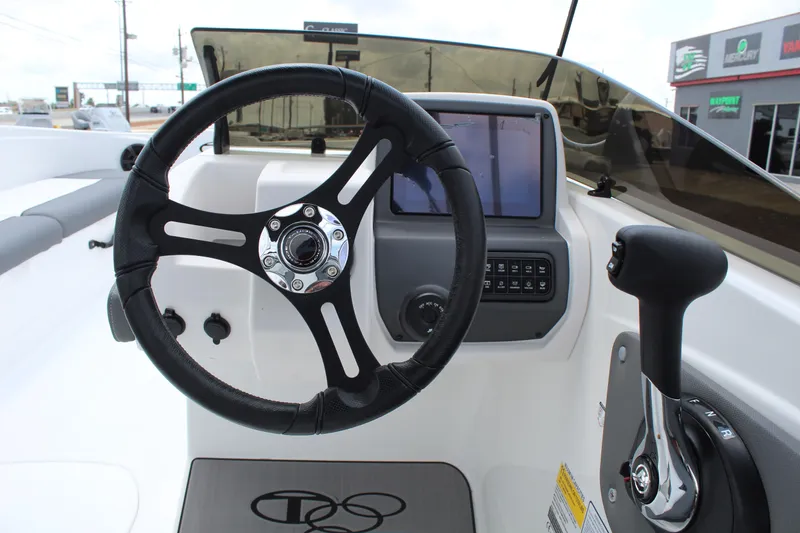 Slide: The Image of Steering console of 2025 Tahoe T21 boat with modern controls and display. - 14