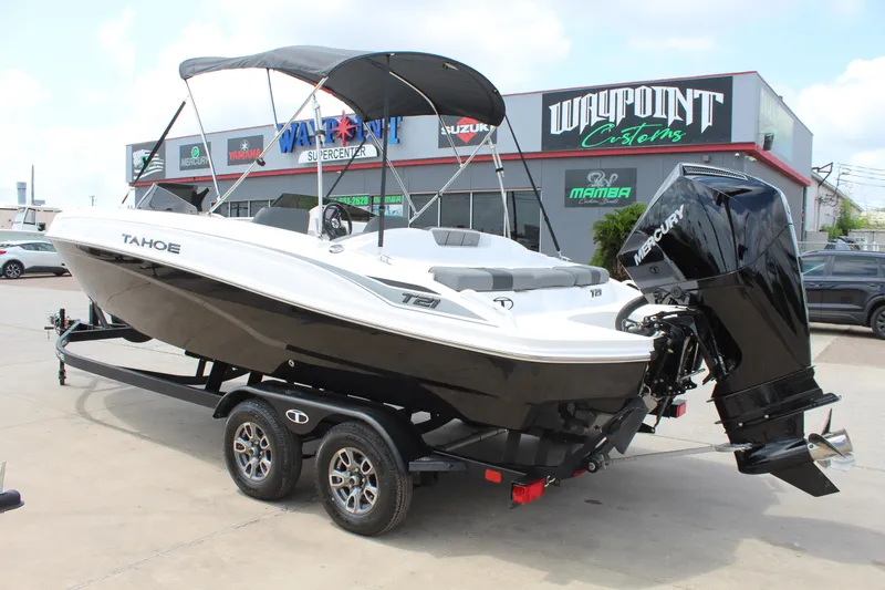 Slide: The Image of 2025 Tahoe T21 boat with canopy and outboard motor on a trailer. - 7