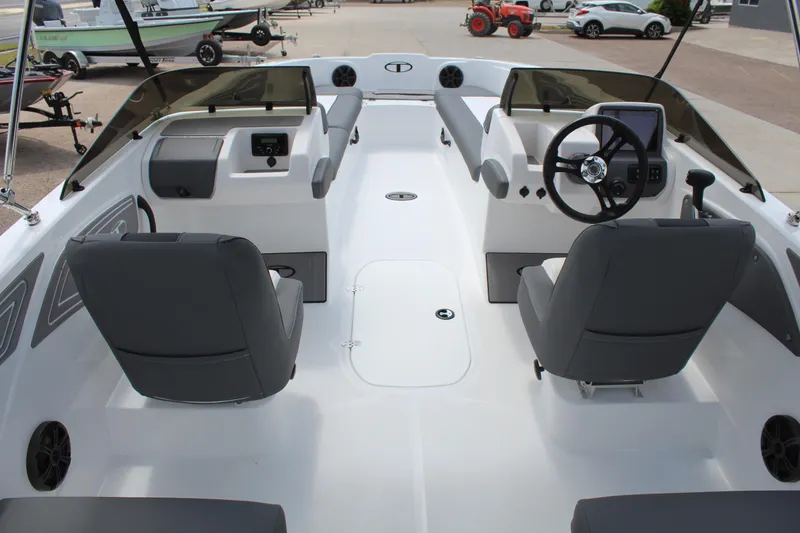 Slide: The Image of Interior of 2025 Tahoe T21 boat with dual consoles and gray seating. - 9