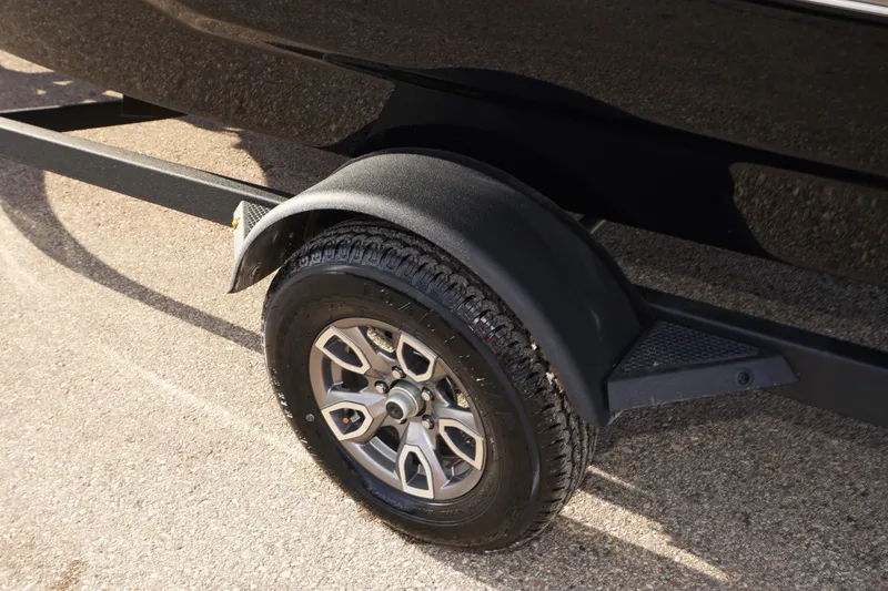 Slide: The Image of 2025 Tahoe T18 trailer wheel and fender on asphalt surface. - 10