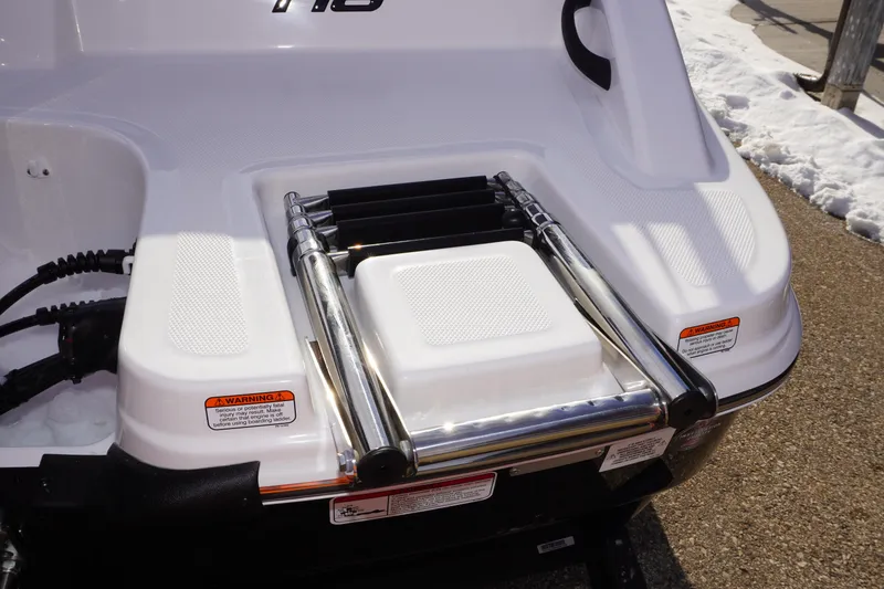 Slide: The Image of 2025 Tahoe T18 boat with foldable ladder on the deck, featuring safety warnings. - 8