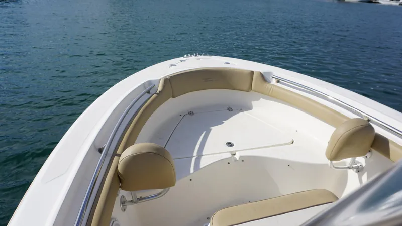 Slide: The Image of 2019 Pioneer 202 Sportfish boat with beige seating on calm water. - 7