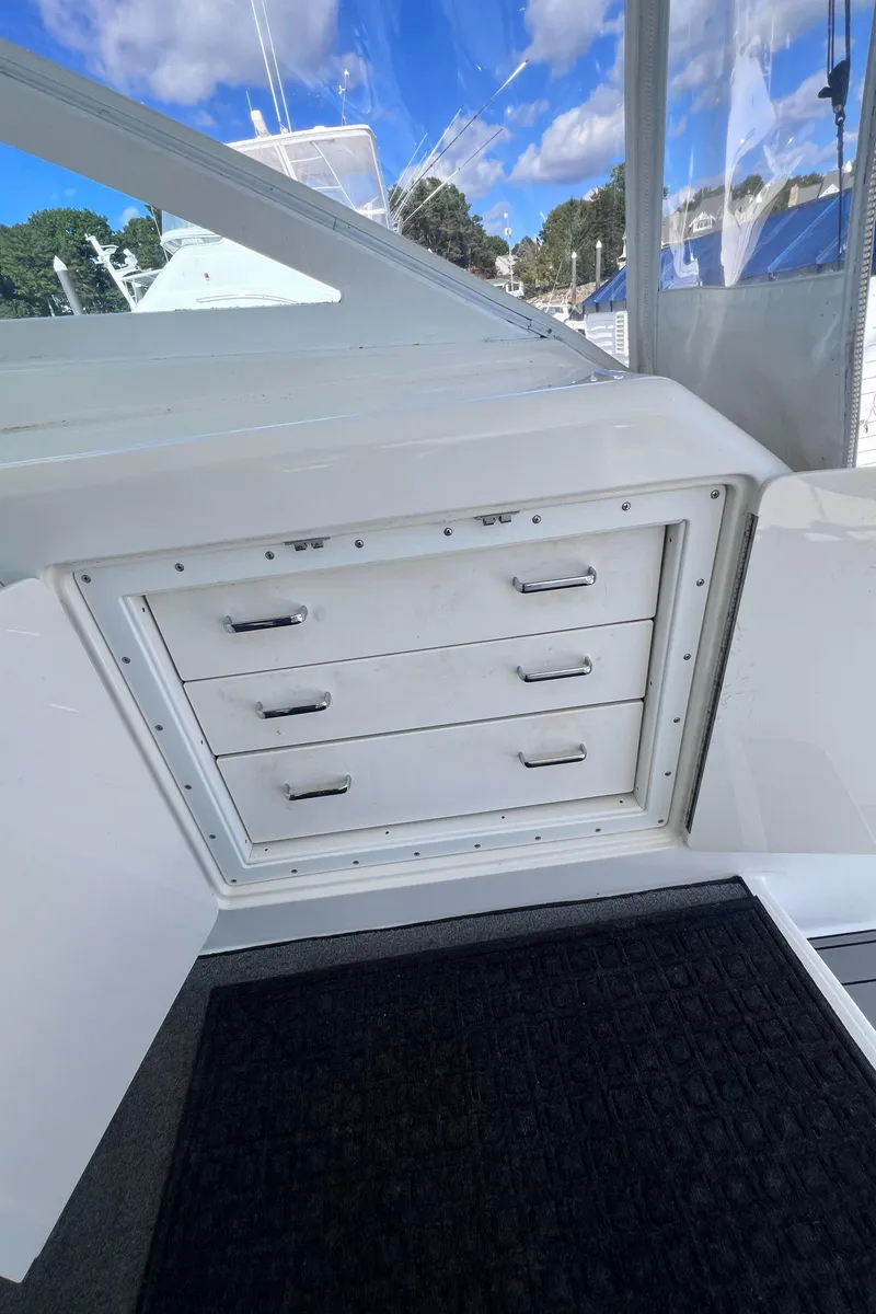 Slide: The Image of Cabo 45 Express 2001 boat interior with storage drawers and open hatch. - 26