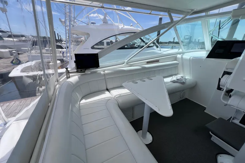 Slide: The Image of Interior of 2001 Cabo 45 Express yacht with white seating and table. - 38