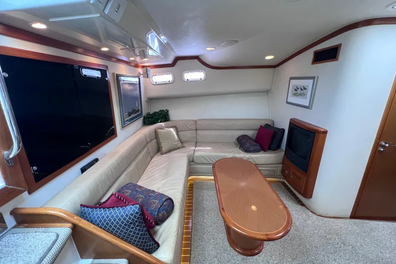Slide: The Image of Luxurious interior of a 2001 Cabo 45 Express yacht with plush seating and elegant decor. - 40