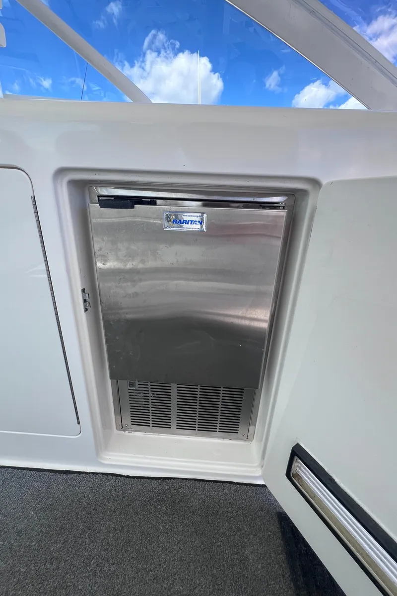 Slide: The Image of Stainless steel fridge on 2001 Cabo 45 Express boat under blue sky. - 7