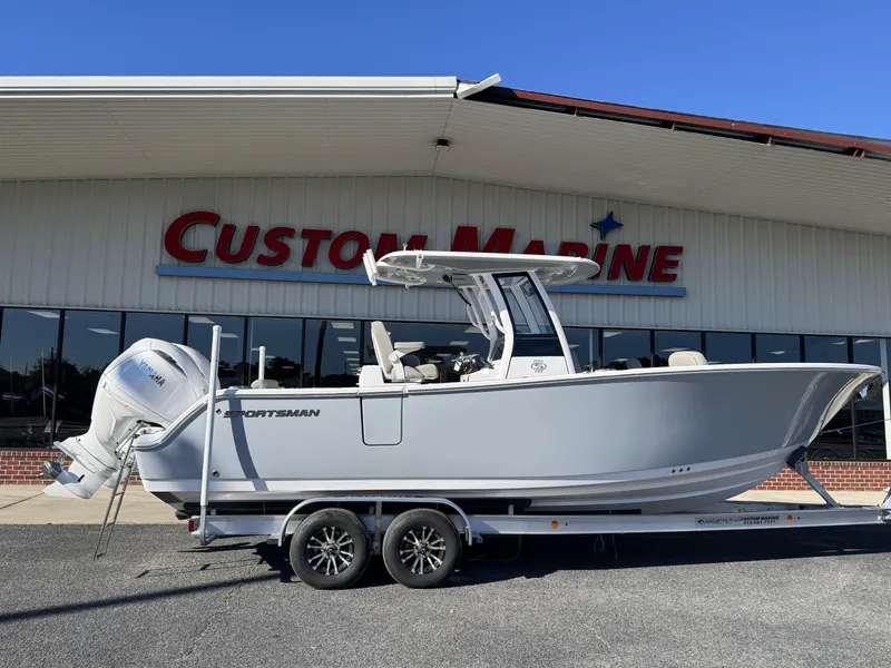 The Image of 2025 Sportsman Open 262 Center Console boat on trailer at Custom Marine dealership. - 1