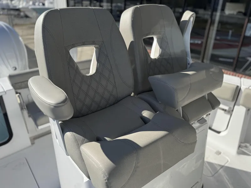 Slide: The Image of 2025 Sportsman Open 262 Center Console boat seats with armrests and diamond stitching. - 12