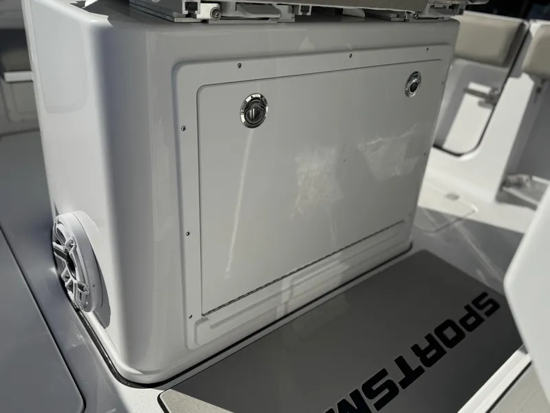 Slide: The Image of 2025 Sportsman Open 262 Center Console boat interior, featuring storage compartment and speaker. - 18