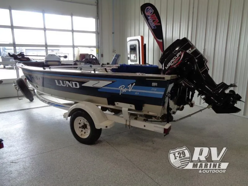 Slide: The Image of 1994 Lund 1775 Pro V boat with Mercury outboard motor in showroom. - 1