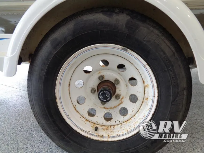 Slide: The Image of Close-up of a 1994 Lund 1775 Pro V trailer wheel with rust spots. - 14