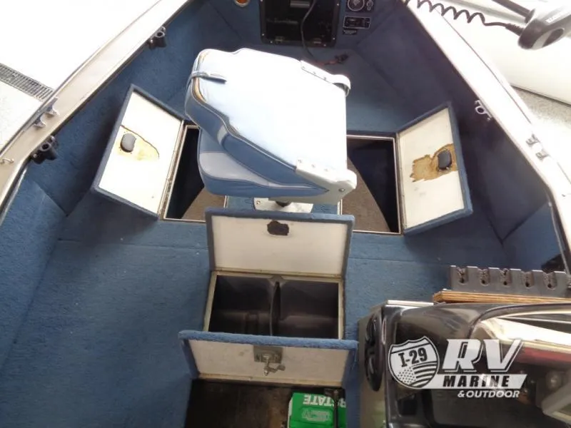 Slide: The Image of Interior of a 1994 Lund 1775 Pro V boat with blue seating and storage compartments. - 15