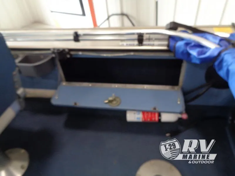 Slide: The Image of Interior of a 1994 Lund 1775 Pro V boat with storage compartment and fishing rod holder. - 16