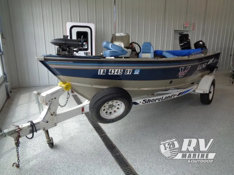 Slide: The Image of 1994 Lund 1775 Pro V fishing boat on ShoreLand'r trailer in indoor showroom. - 2