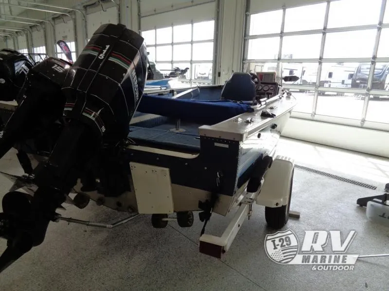 Slide: The Image of 1994 Lund 1775 Pro V boat with outboard motor in showroom. - 3