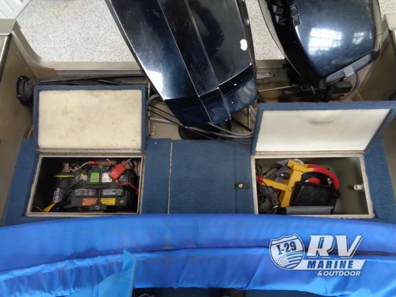 Slide: The Image of 1994 Lund 1775 Pro V boat interior with storage compartments and motor. - 4