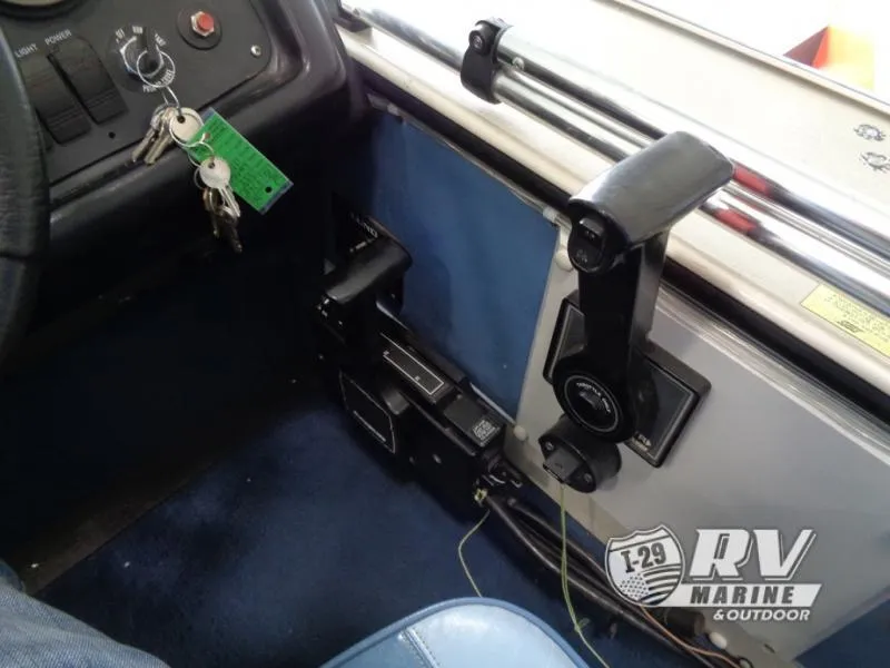 Slide: The Image of 1994 Lund 1775 Pro V boat interior with control panel and keys. - 5