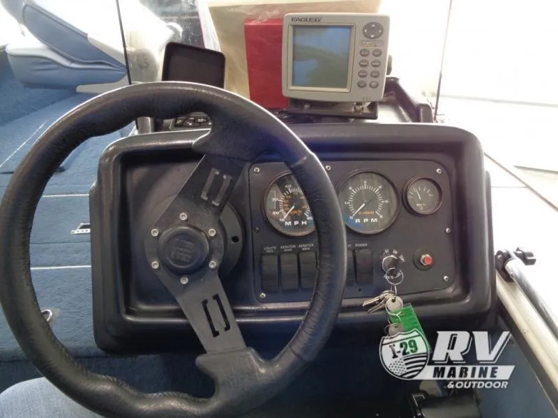 Slide: The Image of 1994 Lund 1775 Pro V boat dashboard with steering wheel and gauges. - 6
