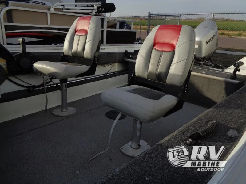 Slide: The Image of 1999 Starfire 160 boat interior with two cushioned seats and Honda outboard motor. - 10