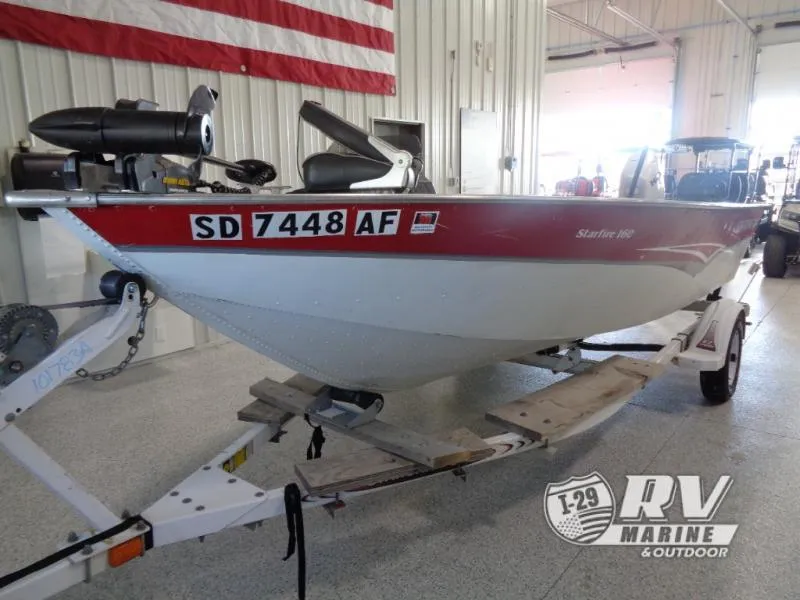 Slide: The Image of 1999 Starfire 160 boat on trailer in indoor showroom. - 3