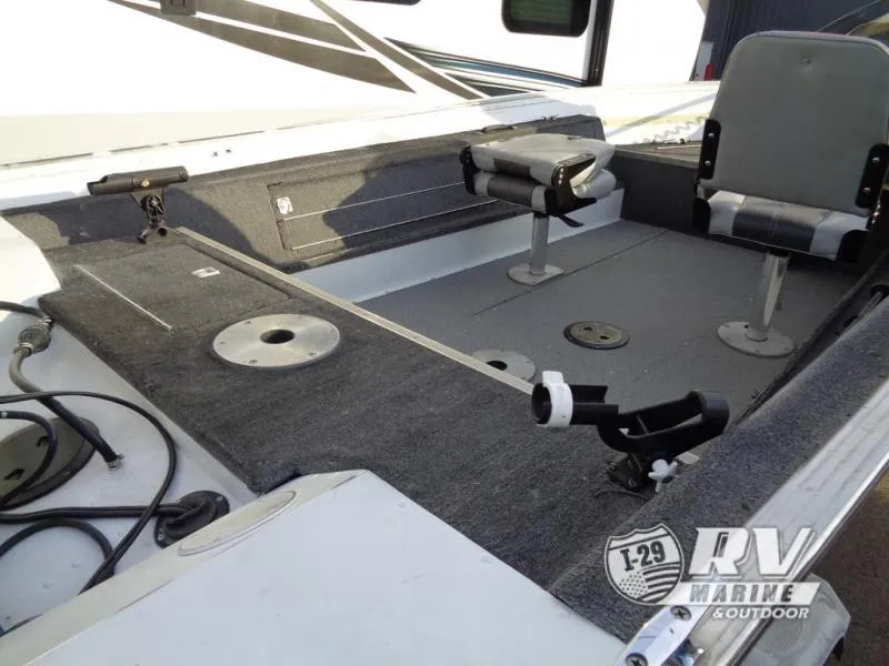 Slide: The Image of 1999 Starfire 160 boat interior with seating and fishing rod holders. - 6
