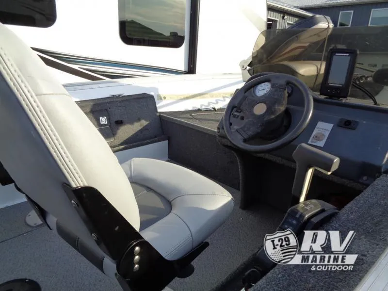 Slide: The Image of 1999 Starfire 160 boat interior with steering wheel and seat, RV Marine logo visible. - 7