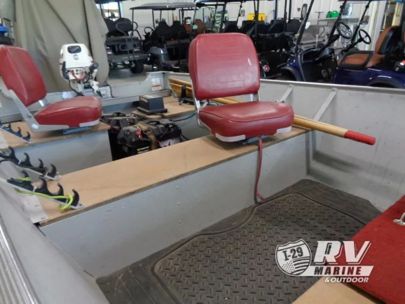 Slide: The Image of 2004 SSV 14 boat interior with red seats and fishing equipment. - 10