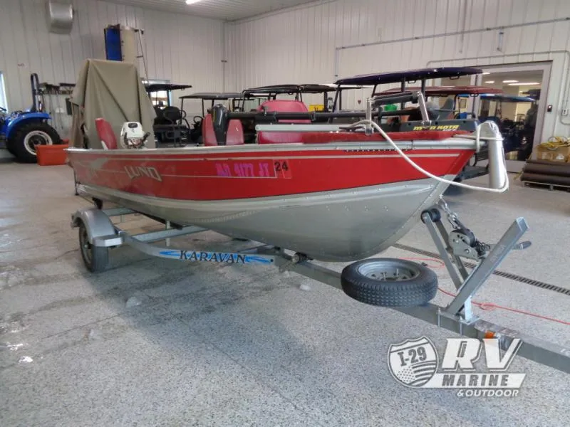 Slide: The Image of Red 2004 SSV 14 boat on trailer in indoor garage setting. - 3