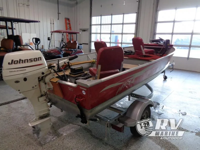 Slide: The Image of 2004 SSV 14 boat with Johnson outboard motor in a garage setting. - 4