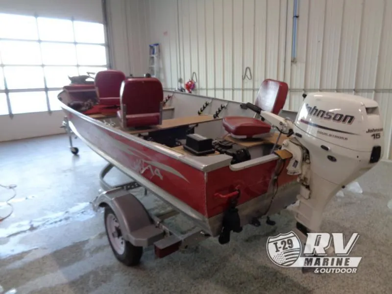 Slide: The Image of 2004 SSV 14 boat with Johnson 15 outboard motor in a garage setting. - 5