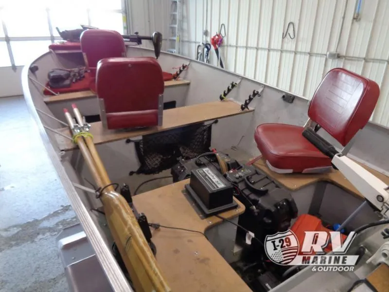 Slide: The Image of 2004 SSV 14 boat interior with red seats and fishing equipment in a garage. - 7