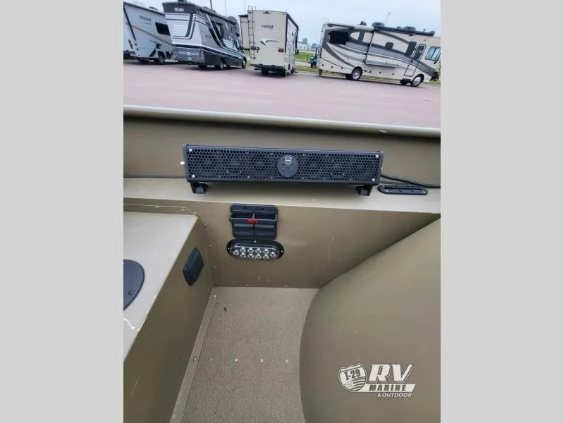 Slide: The Image of 2015 G3 1860SC DLX boat interior with speaker and control panel, RVs in background. - 10