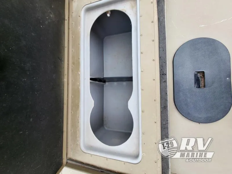 Slide: The Image of Open storage compartment in 2015 G3 1860SC DLX boat, with RV Marine logo. - 9
