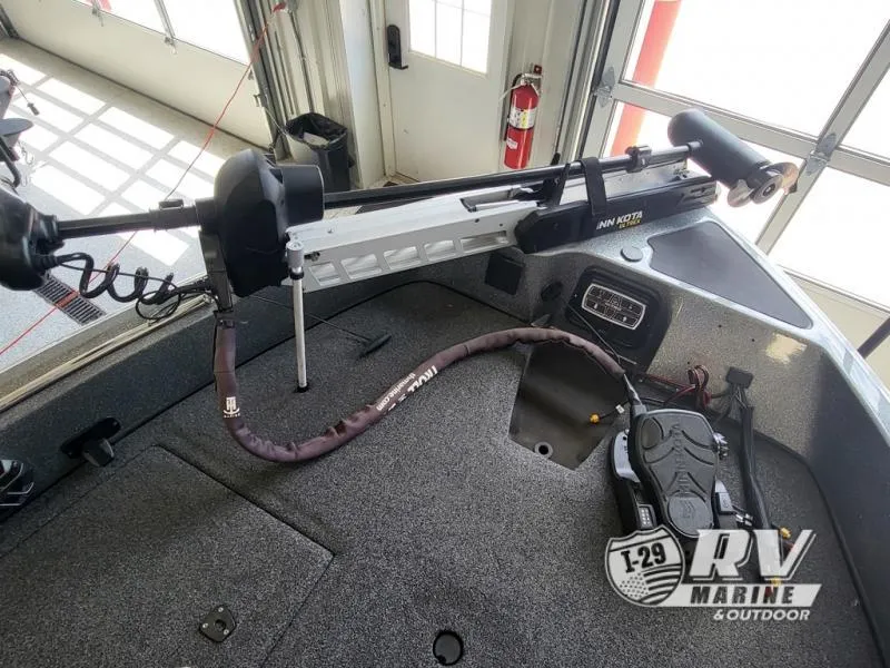 Slide: The Image of 2018 Nitro ZV21 boat with Minn Kota trolling motor in a garage setting. - 5