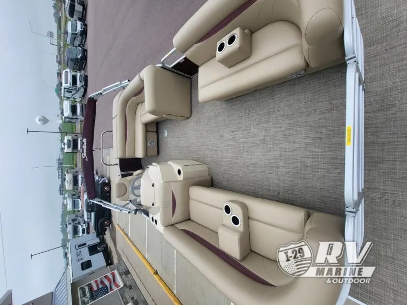 Slide: The Image of 2018 Cruisers 2086 pontoon boat with beige seating and cup holders, displayed at RV Marine. - 4