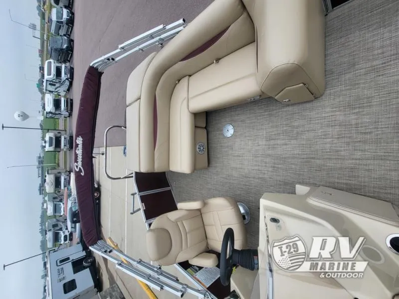 Slide: The Image of 2018 Cruisers 2086 boat interior with beige seating and steering wheel, displayed at RV Marine & Outdoor. - 5