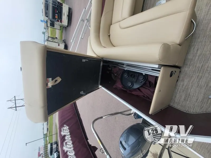Slide: The Image of 2018 Cruisers 2086 boat interior with tan seating and storage compartment. - 6