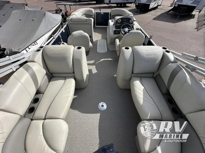 Slide: The Image of 2018 Mirage 8522 pontoon boat interior with beige seating and steering console. - 13