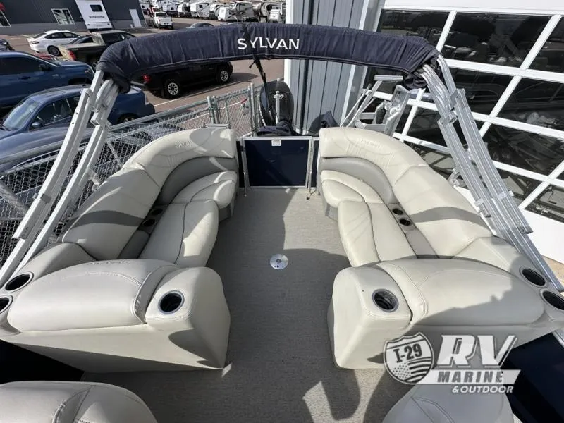 Slide: The Image of 2018 Mirage 8522 pontoon boat with beige seating and Sylvan canopy at RV Marine dealership. - 15