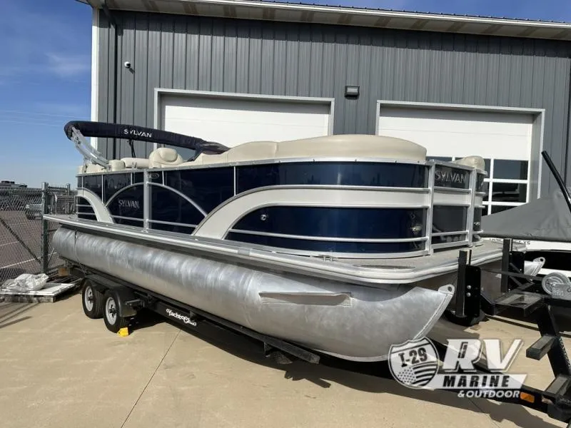 Slide: The Image of 2018 Mirage 8522 pontoon boat on trailer outside RV Marine store. - 2